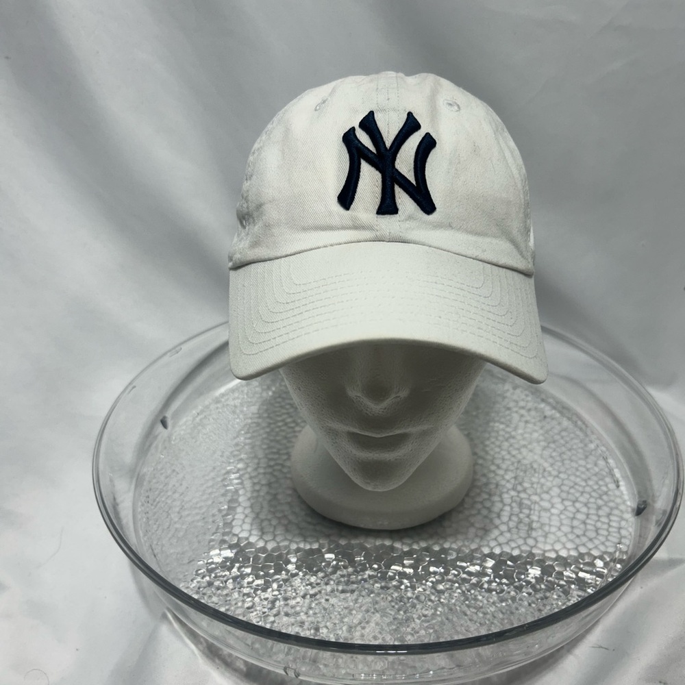 White Cap with embroidered navy blue NY Logo.